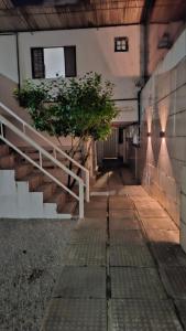 an empty hallway of a building with a tree at Pousada São Paulo - Quartos com WC Exclusivo in Recife