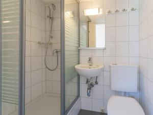 a bathroom with a shower and a toilet and a sink at Villa Taube XL in Bad Gastein +25 photos