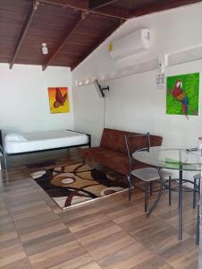 a living room with a bed and a table at Apartamentos GoZu # 1 in Puerto Viejo