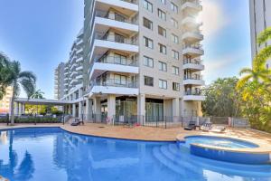a swimming pool in front of a building at Spacious Darwin Esplanade Retreat with Pool & Spa in Darwin