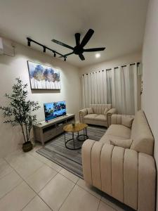 a living room with a couch and a ceiling fan at Homestay D'Aina in Teluk Intan
