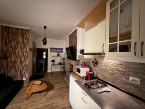 a kitchen with white cabinets and a table in a room at Casa Di Carla in Canino