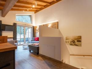 a kitchen and living room with a staircase in a house at Pinzgau Lodge 2B in Wald im Pinzgau