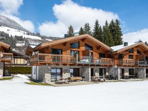 a ski lodge with snow in front of it at Pinzgau Lodge 2B in Wald im Pinzgau