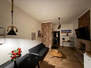a living room with a couch and a tv at Casa Di Carla in Canino