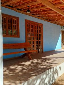 a wooden bench sitting in front of a building at Chalé vale do Monte Verde in Camanducaia +10 photos