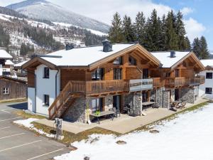 a log home in the mountains with snow at Pinzgau Lodge 1A in Wald im Pinzgau