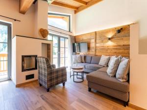 a living room with a couch and a chair at Pinzgau Lodge 1B in Wald im Pinzgau