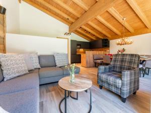 a living room with a couch and a table at Pinzgau Lodge 1B in Wald im Pinzgau