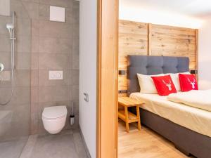 a bathroom with a bed and a shower and a toilet at Pinzgau Lodge 1B in Wald im Pinzgau +28 photos