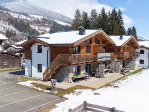a home in the mountains with snow on the ground at Pinzgau Lodge 1B in Wald im Pinzgau
