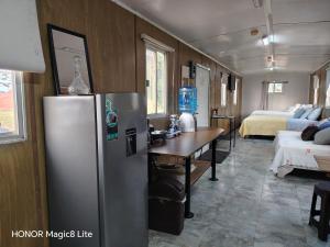 a kitchen with a refrigerator and a table in a room at Quinta Aroma Zempoala in Zempoala +10 photos