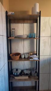 a shelf filled with pots and pans and bowls at Casa 89 in Itacaré