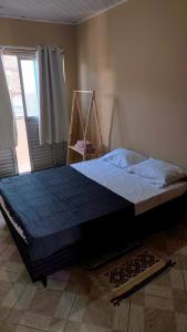 a bedroom with a large bed in a room at Casa 89 in Itacaré