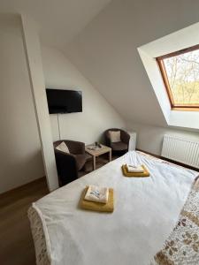 a bedroom with a large bed with a window at Penzion Amfik in Mikulov