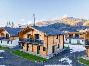 a group of houses with mountains in the background at Rattendorf 21A in Rattendorf