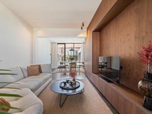 a living room with a couch and a tv at Pastorie Liezele in Puurs