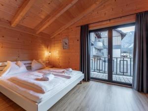 a bedroom with a bed and a large window at Rattendorf 21A in Rattendorf
