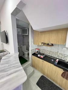 a small kitchen with a sink and a toilet at Great duplex in Monastir in Monastir