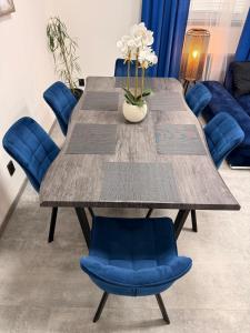 a wooden table and blue chairs in a room at Teplice Apartments 2 in Teplice +42 photos