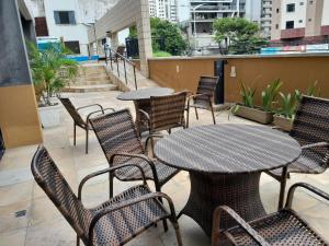 an outdoor patio with tables and chairs and stairs at FLAT SAINT MARTIN Apto 308 in Fortaleza