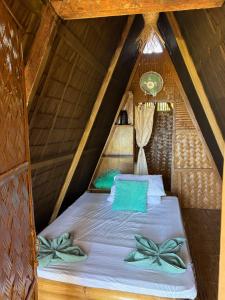 a bed in a room in a attic at Lumindas Beach Resort in Sabang