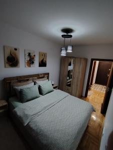 a bedroom with a large bed with blue pillows at Apartman Fenix in Pirot +27 photos