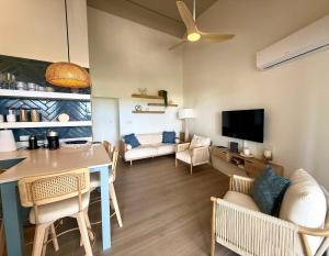 a living room with a dining table and a couch at Lantana Sea La Vie - by ZenBreak in Saint James