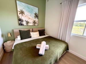 a bedroom with a bed with a towel on it at Lantana Sea La Vie - by ZenBreak in Saint James