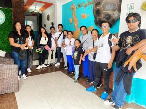 a group of people posing for a picture in a room at Casa Galarous Island in Puerto Ayora