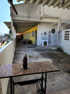 a room with a table and a yellow building at Recanto na Praia com Vista Mar in Mangaratiba +30 photos