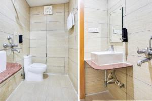 a bathroom with a toilet and a sink at Collection O Bhiwadi in Bhiwadi