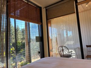 a bedroom with a bed and a large window at Converted Farm Loft in Casablanca