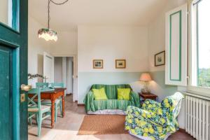 a living room with a green couch and a table at Podere Oliveta in Poggibonsi +51 photos