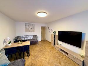 a living room with a large flat screen tv at Duchcov Apartments in Teplice