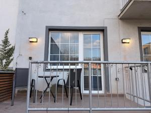 a balcony with a table in front of a window at Duchcov Apartments in Teplice