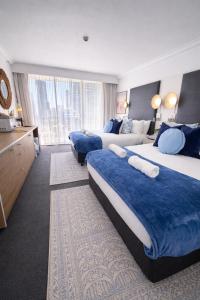 a hotel room with two beds and a large window at Oceans 11 in Gold Coast