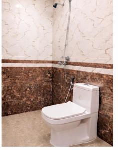 a bathroom with a white toilet in a room at Romana mansion in Calangute +17 photos