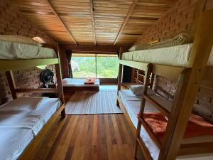 a room with three bunk beds and a window at Wisdom Forest Lodge in Tena