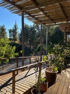a porch with potted plants on a wooden deck at Converted Farm Loft in Casablanca