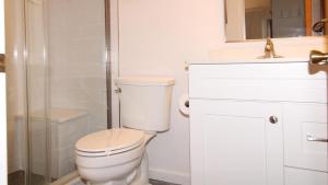 a white bathroom with a toilet and a shower at Somewhere In Time Unit 4 in Cape May Point +10 photos