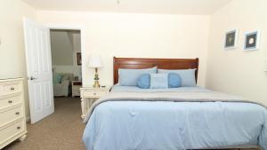 a bedroom with a large bed with blue pillows at 324 First Ave in West Cape May +32 photos