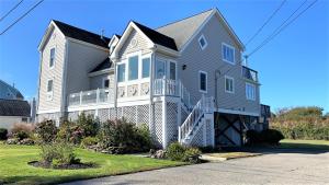 a large gray house with a porch and stairs at 324 First Ave in West Cape May