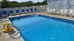 a large swimming pool with chairs and a pool noodle at 324 First Ave in West Cape May