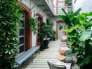 a corridor of a building with plants and a bench at Hôtel Mercure Montauban in Montauban