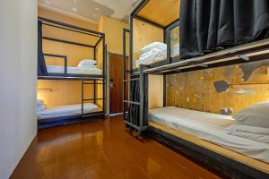 a room with two bunk beds in a building at Mingle Lekiu in Kuala Lumpur