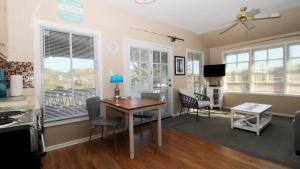 a kitchen and dining room with a table and chairs at 202 Ocean Unit 6 in Cape May Point