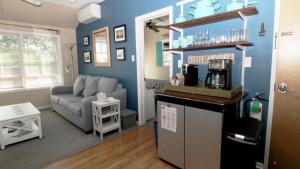 a living room with a couch and a kitchen at 202 Ocean Unit 6 in Cape May Point +14 photos