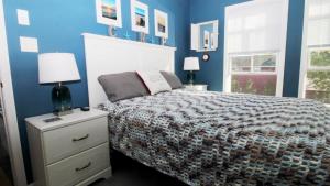 a bedroom with a bed and a blue wall at 202 Ocean Unit 6 in Cape May Point