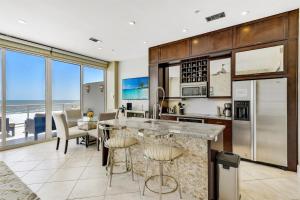 a kitchen with a view of the ocean at XL Terrace, Lazy River, I-O Pools, Game Room, Spa, Beach, Luxury 2-2 Penthouse! in Galveston